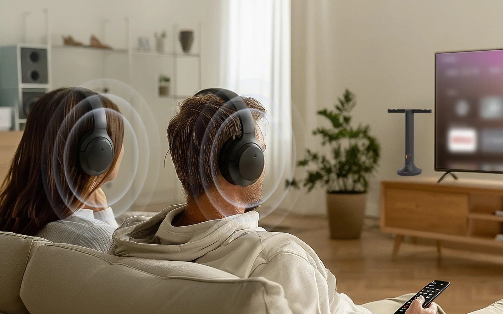 Two people enjoying TV together through separate wireless headphones