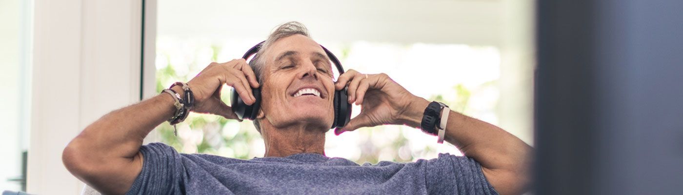 Senior citizen loving his wireless headphones