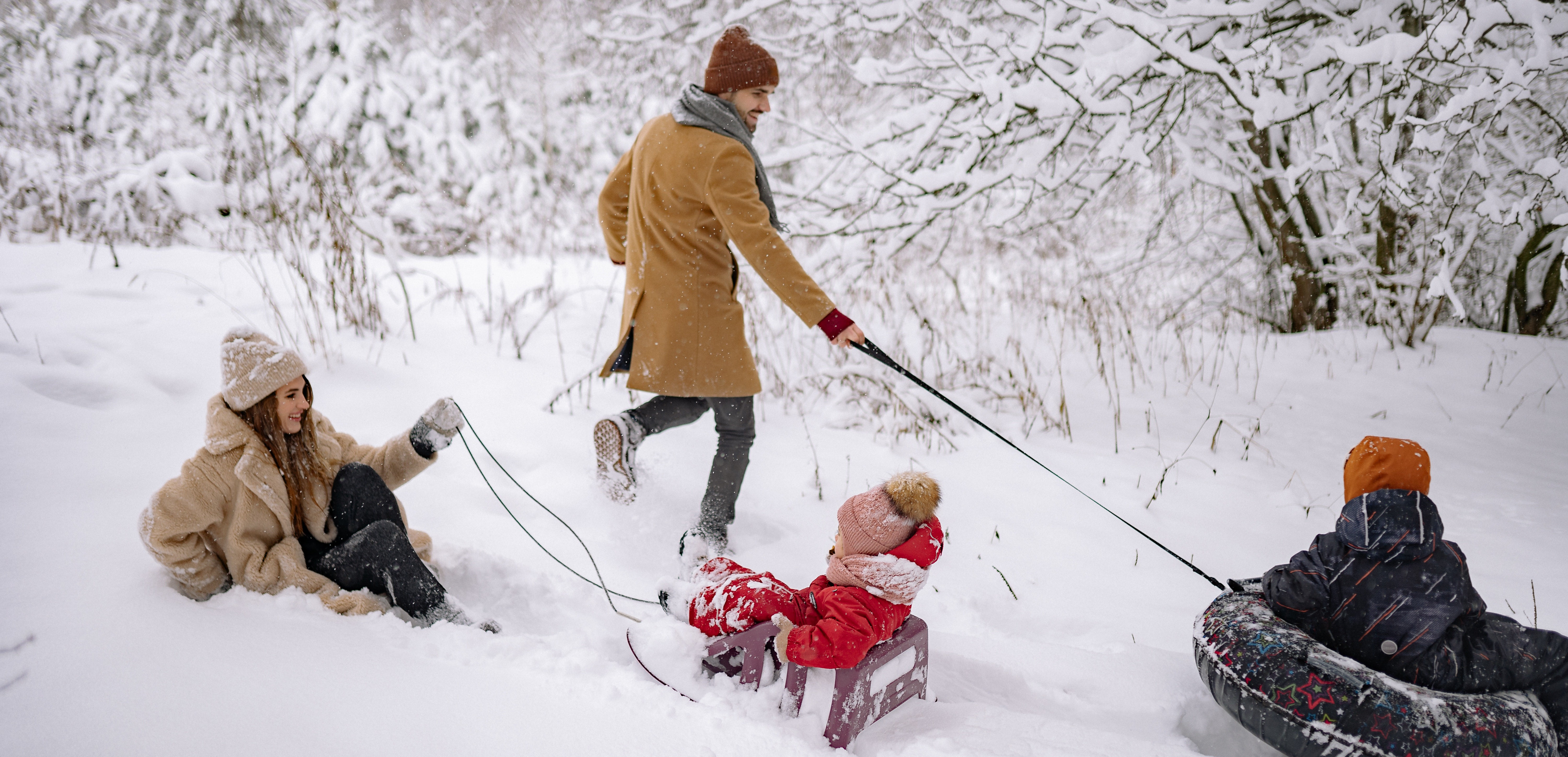 family of four playing in snow